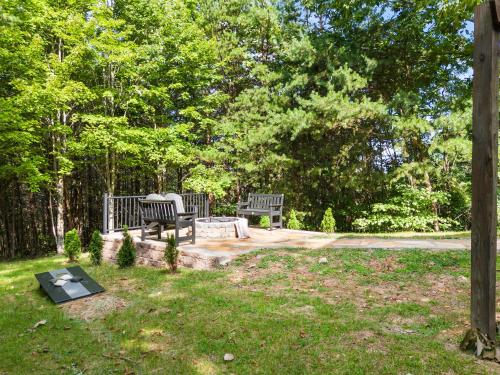 two benches sitting on a patio in a park at Relaxing Escape Pool Access & Close to Dollywood in Pigeon Forge
