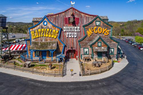 a large wooden barn with graffiti on the side of it at Cozy Retreat awaits w Pool Grill Near Dollywood in Pigeon Forge