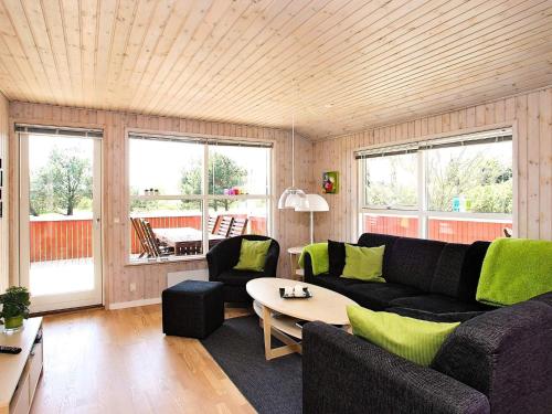 a living room with a couch and a table at 4 star holiday home in Hjørring in Lønstrup