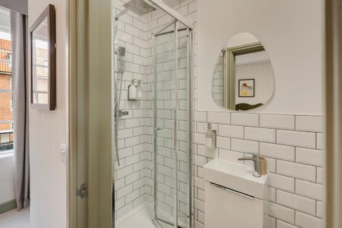 a white bathroom with a sink and a mirror at Hotwells I Your Apartment in Bristol