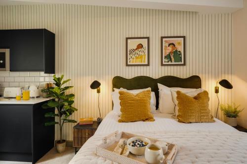 a bedroom with a bed with a tray of food on it at Hotwells I Your Apartment in Bristol