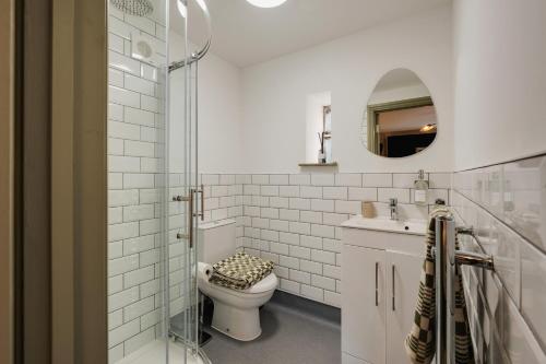 a bathroom with a toilet and a sink and a mirror at Hotwells I Your Apartment in Bristol
