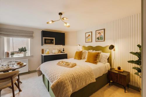 a bedroom with a large bed and a table with a table at Hotwells I Your Apartment in Bristol
