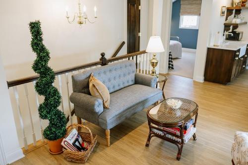 a living room with a blue couch and a plant at The Rochester Inn in Sheboygan Falls