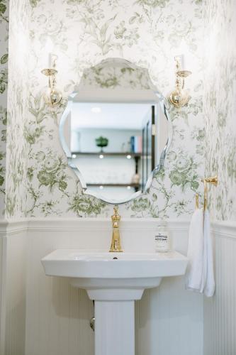 a bathroom with a sink and a mirror at The Rochester Inn in Sheboygan Falls