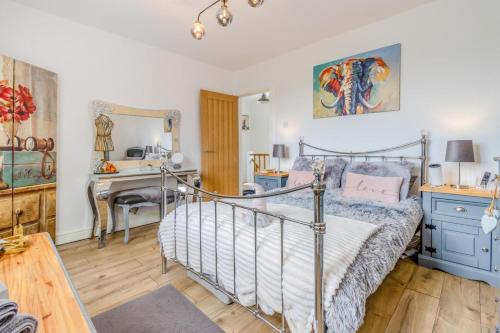 a bedroom with a bed and a desk and a mirror at 3 Bed in Forden oc-c30173 in Forden