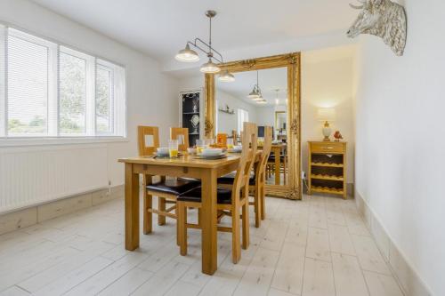 a dining room with a table and chairs and a mirror at 3 Bed in Forden oc-c30173 in Forden