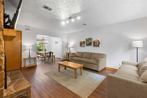 a living room with a couch and a table at Ideal location Shared Pool & Near Dollywood in Pigeon Forge