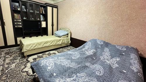 a room with two beds and a tv in it at Sim-Sim Hostel in Panjakent