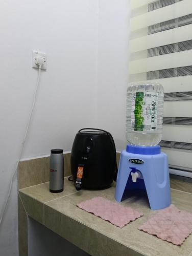 a blender on a counter next to a bag at Air Puteri Rest House in Mersing