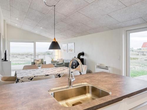 a kitchen with a sink and a living room at 6 person holiday home in Læsø-By Traum in Læsø