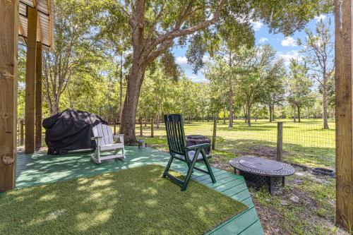 a patio with a chair and a table and a tent at Ruby Oaks Campsite 