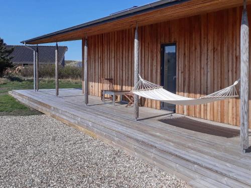 a porch with a hammock on a house at 8 person holiday home in Vestervig-By Traum in Vestervig