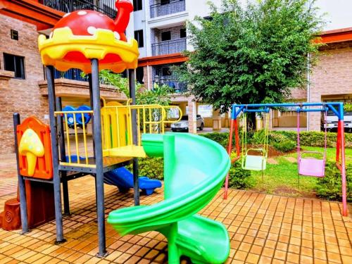 a playground with a slide in a yard at modern executive three bedroom apartment which features a swimming pool, state of the art fully equipped gym and all modern unmatched luxurious facilities which offfers luxury lifestyle in Nairobi