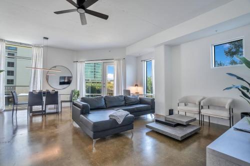 a living room with a couch and a ceiling fan at 3 bedroom Corner Suite in Orlando
