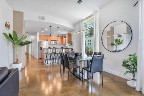 a dining room and living room with a table and chairs at 3 bedroom Corner Suite in Orlando