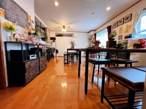 a restaurant with tables and chairs in a room at ｄｐ小山町 in Machida
