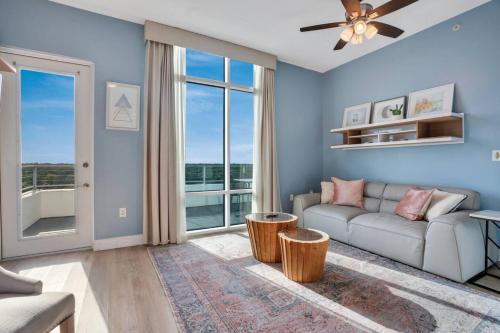 a living room with a couch and a large window at 2 Bdrm Penthouse with Billiards in Orlando