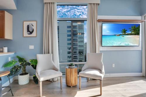 a living room with two chairs and a view of the ocean at 2 Bdrm Penthouse with Billiards in Orlando