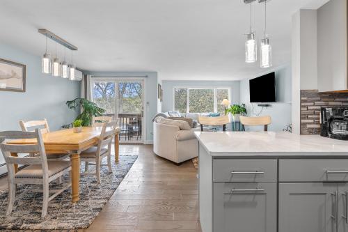 a kitchen and living room with a table and a dining room at Water View Home with Hot Tub Balcony Pool and Tennis in Mashpee