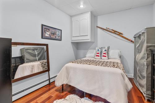 a bedroom with a bed and a mirror at Water View Home with Hot Tub Balcony Pool and Tennis in Mashpee