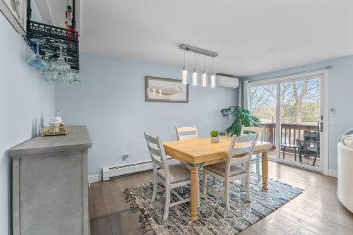 a dining room with a wooden table and chairs at Water View Home with Hot Tub Balcony Pool and Tennis in Mashpee