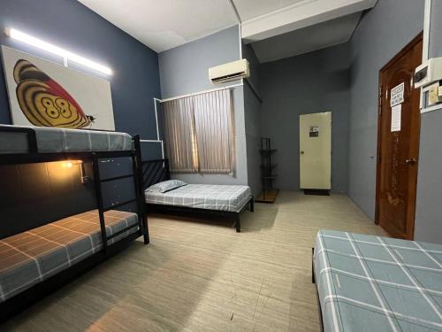 a room with two bunk beds and a window at The Eighty8 PP in Phnom Penh