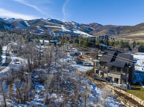 an aerial view of a house with mountains in the background at White Pine Luxe Family Retreat with Views in Snyderville
