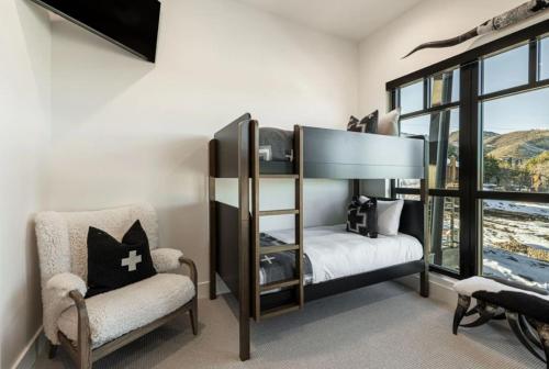 a bedroom with a bunk bed and a chair at White Pine Luxe Family Retreat with Views in Snyderville