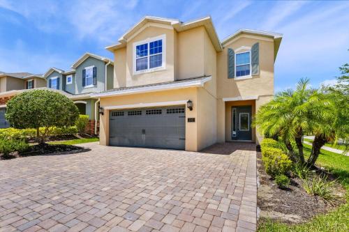 a house with a driveway in front of it at Luxury Home With Private Pool And Water Park & Resort Access Near Disney At Encore Resorts Reunion - 240Mn in Kissimmee