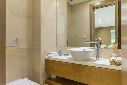 a bathroom with a bowl sink and a mirror at Aluma 2-BR Apt & Balcony at Waterfront Dbayeh in Dbayeh