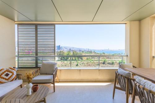 a living room with a large window with a view at Aluma 2-BR Apt & Balcony at Waterfront Dbayeh in Dbayeh