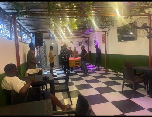 a group of people playing a video game in a room at Merit Hotel & lounge in Bale Akiosi