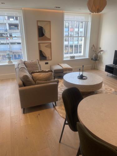 a living room with a couch and a table at Northwest Apartment in London
