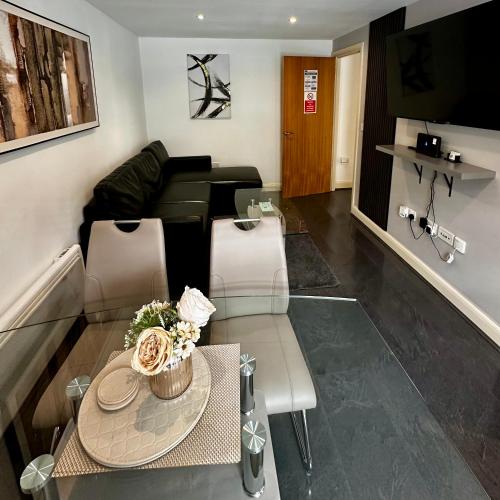 a living room with a table and a couch at 2 Bedroom Flat Ground Floor Town Centre Colchester in Colchester