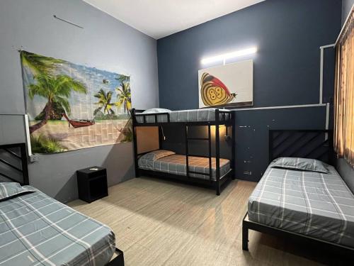 a room with two bunk beds and a painting on the wall at The Eighty8 PP in Phnom Penh