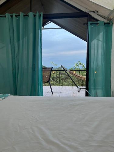 a bedroom with a bed in a tent with a view at Glamping Finca garza del sol in El pilon