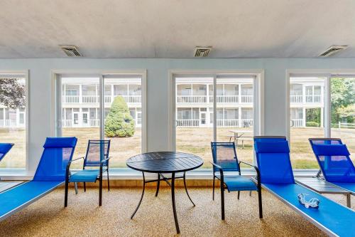 a room with a table and chairs and windows at Wellington Manor 240 in Wells