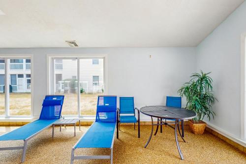 a dining room with blue chairs and a table at Wellington Manor 240 in Wells