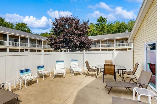 a patio with chairs and a table and a fence at Wellington Manor 240 in Wells