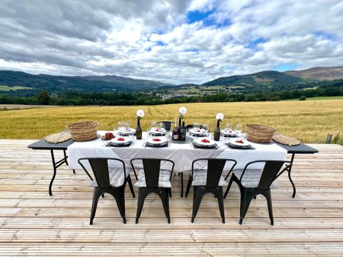 a table with a white table cloth and baskets on it at InEdra Estate Farmhouse by edradour1725 in Pitlochry
