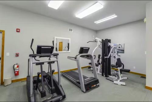 a gym with treadmills and machines in a room at Water View Home with Hot Tub Balcony Pool and Tennis in Mashpee