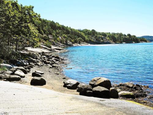 a group of rocks on the shore of a body of water at 5 person holiday home in LJUNGSKILE-By Traum in Ljungskile