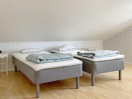 two beds are sitting in a room with at 8 person holiday home in VALDEMARSVIK in Valdemarsvik