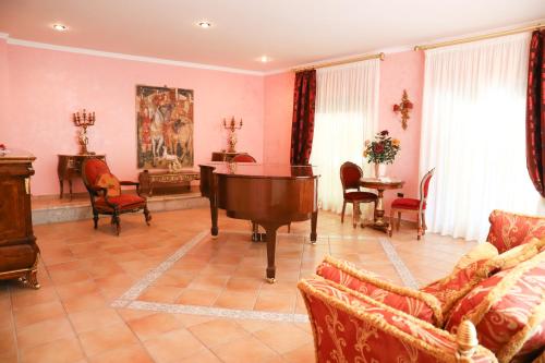 a living room with a grand piano and chairs at IL Tetto Di Guardia in Guardia Sanframondi