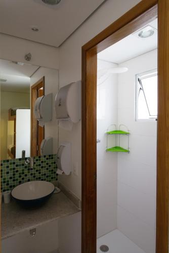 a bathroom with a sink and a mirror at Brazilodge All Suites Hostel in São Paulo
