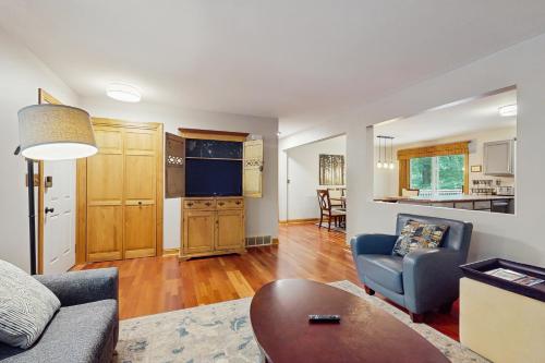 a living room with a couch and a table at Red Arrow Lodge in Sawyer