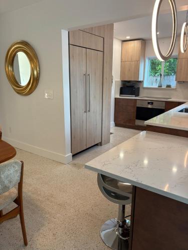 a kitchen with a table and a counter top at Mid-Century with Outdoor Oasis in Fort Lauderdale