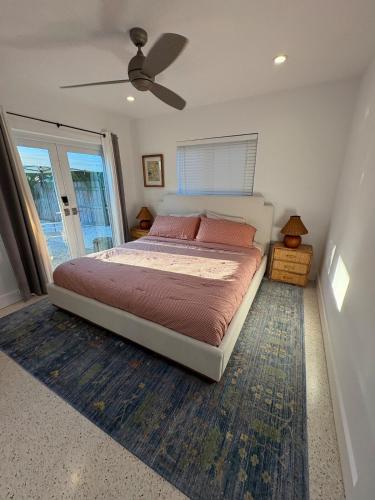 a bedroom with a bed and a ceiling fan at Mid-Century with Outdoor Oasis in Fort Lauderdale
