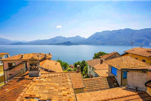 a view of a lake from the roofs of houses at Appartamento Ronco in Ghiffa